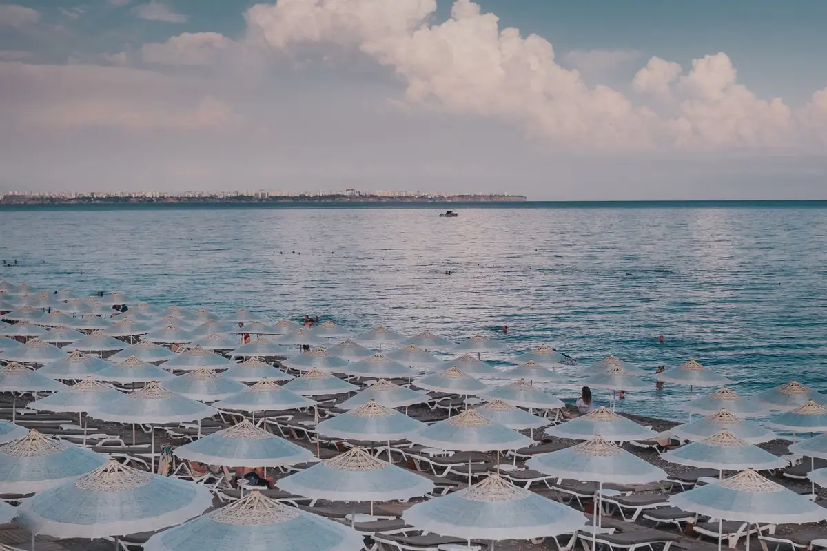 Rows of beach umbrellas on a Mediterranean beach