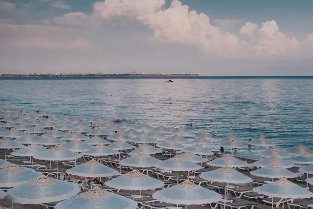 Rows of beach umbrellas on a Mediterranean beach