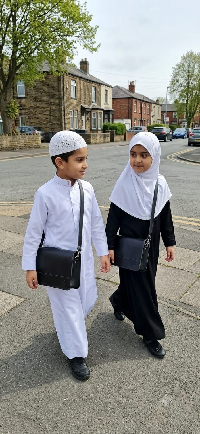 A boy and girl walking to madrasah along a UK street, each carrying a black leather madrasah bag (madrasa bag) across the body