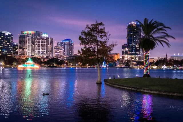 The Orlando skyline lit up at night beside a lake