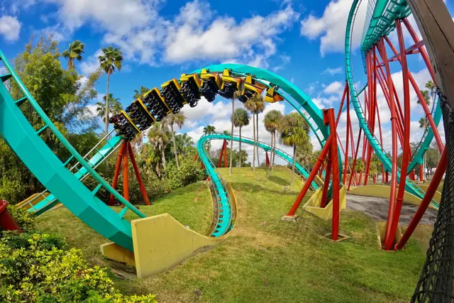 A colourful rollercoaster loop under a blue sky