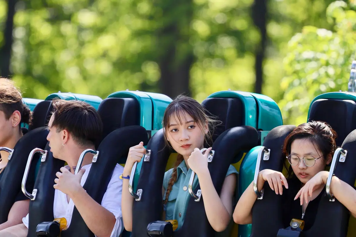 Friends strapped into a rollercoaster car