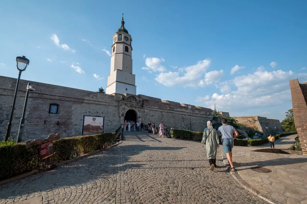 Visitors walking towards the clock tower gate of Kalemegdan Fortress in Belgrade