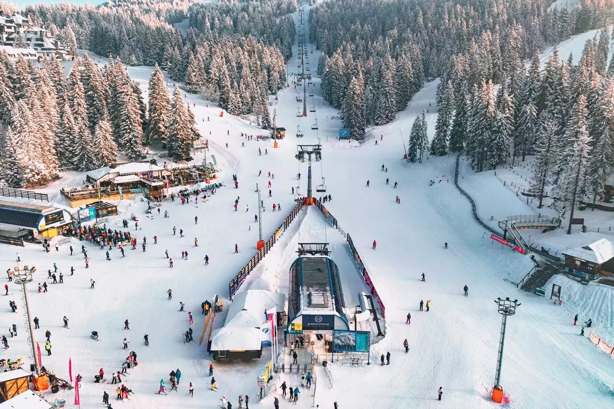 A busy ski slope covered in snow