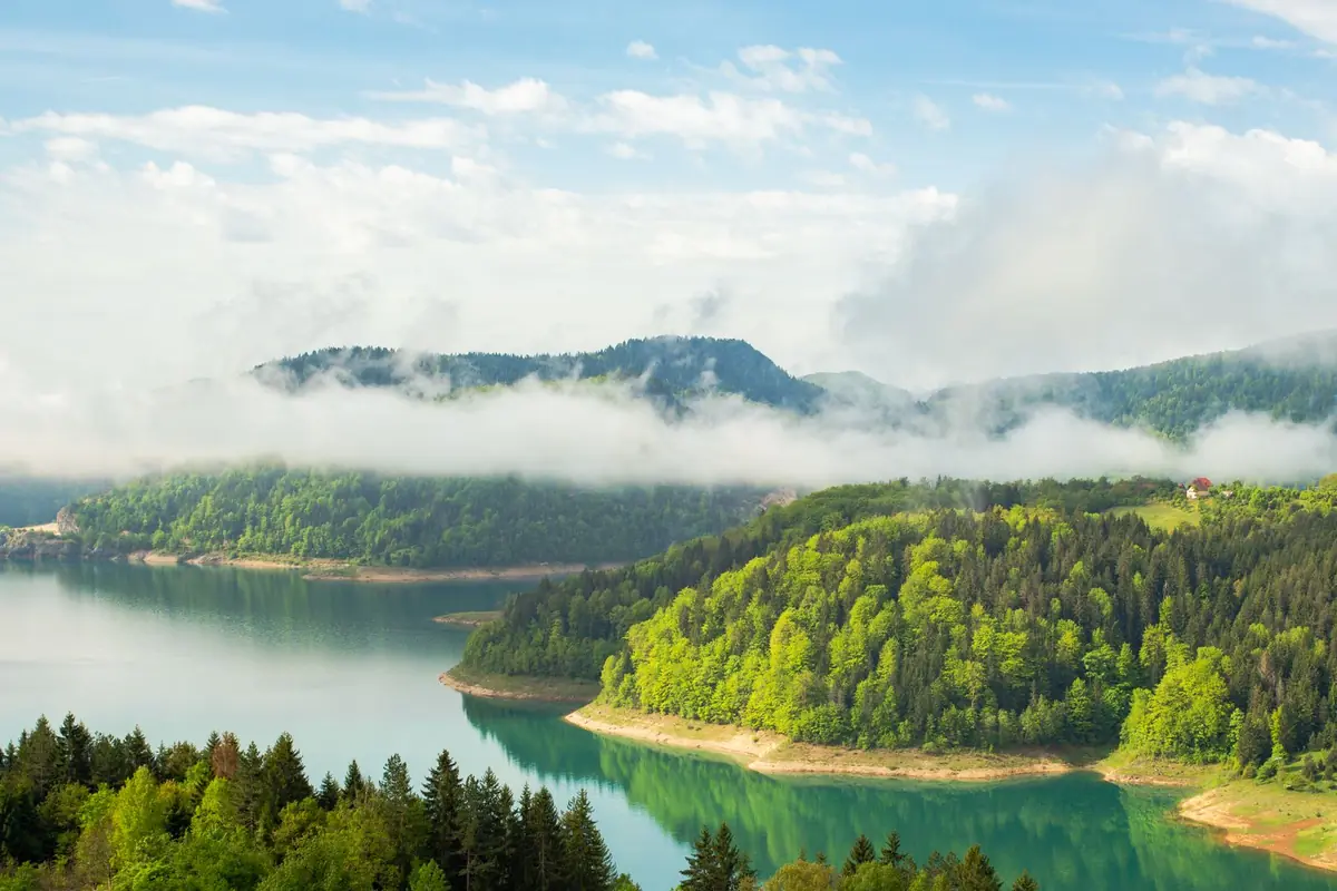 A mountain lake surrounded by green forest in Tara National Park